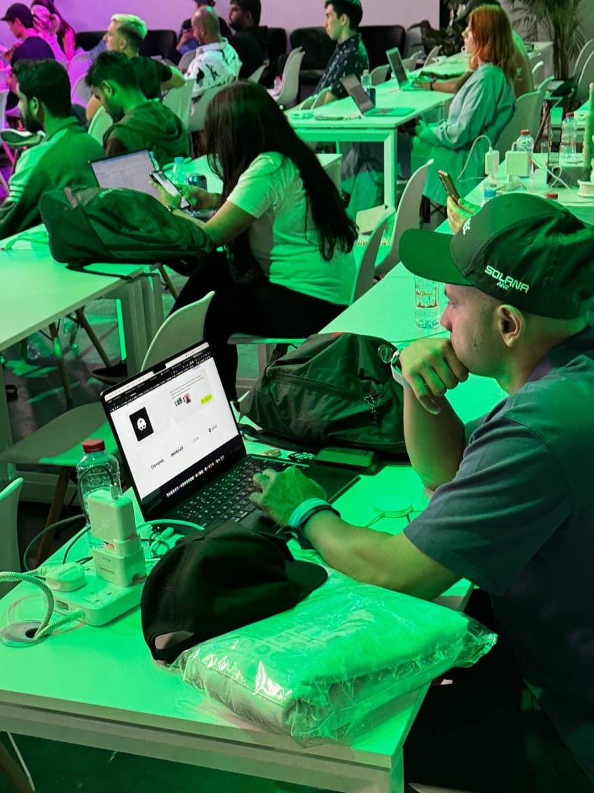 Historical photo of builderz.dev open on a laptop at a Solana Hacker House table in Dubai.